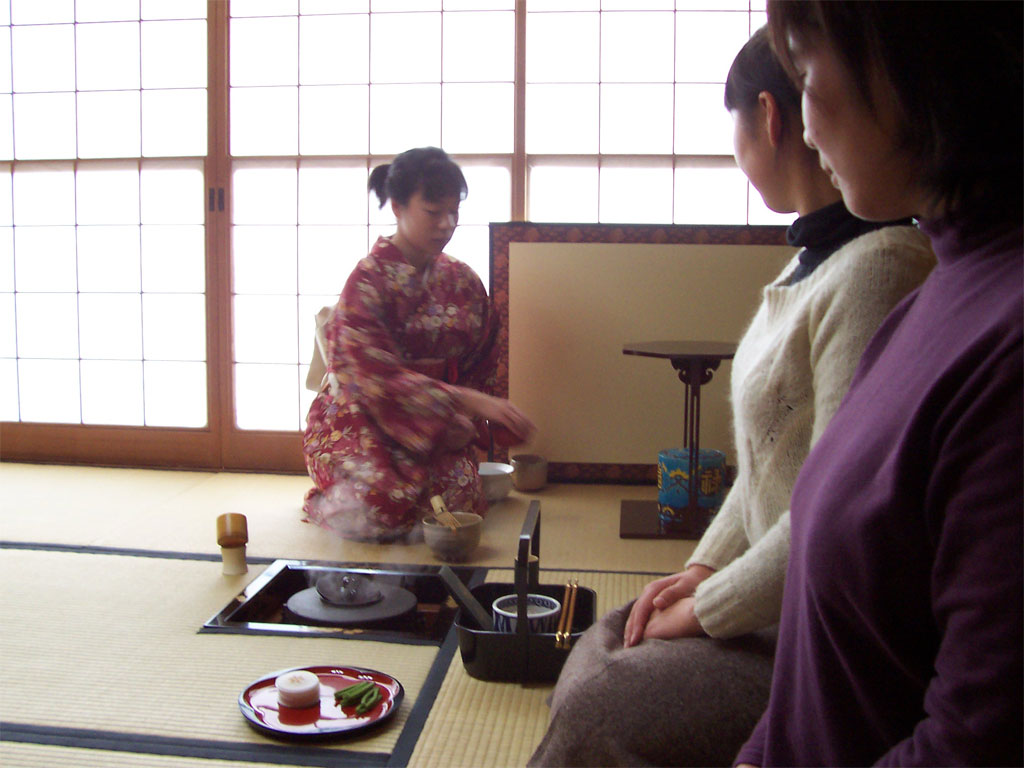 Mika performing the tea ceremony, while Yuko and Ryoko look on.